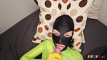 The dick is sucked by SpandexQueen, who then comes back twice wearing her green spandex leggings and makes him cum on her mask.