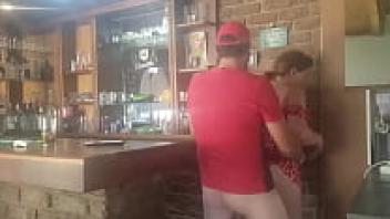 A brunette MILF receives affection from behind.