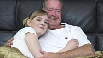A gorgeous blonde stoops to receive affection from her grandfather's large penis.